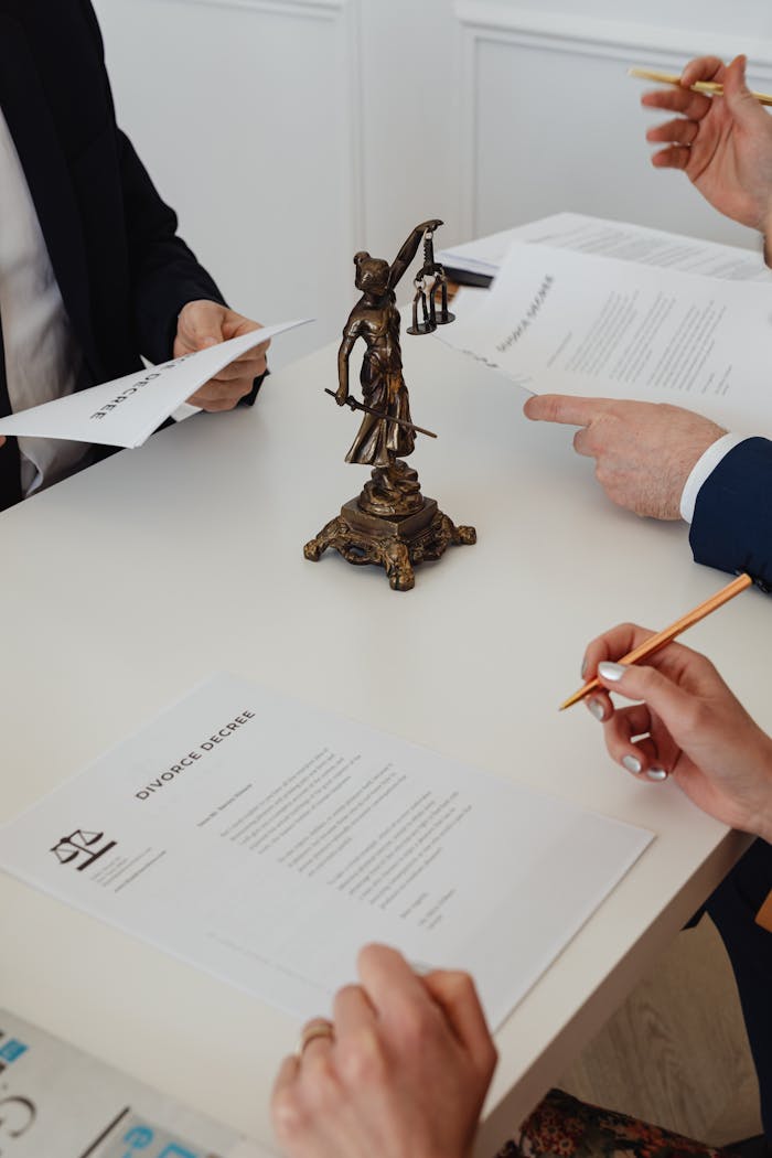 about-us-01 Three professionals reviewing divorce papers in a law office setting.